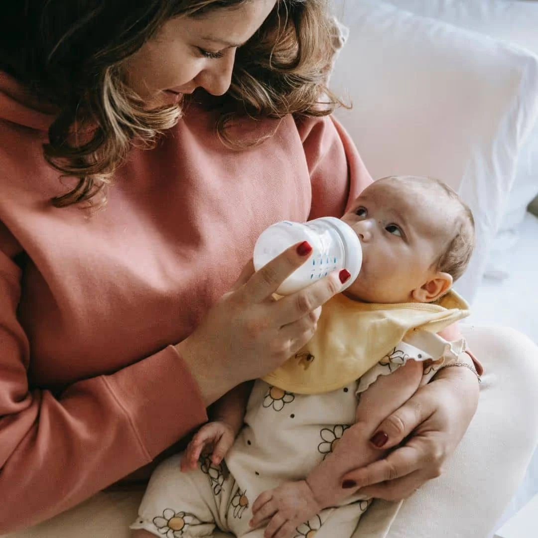 Madre amamantando a su bebé | Demanda de NEC